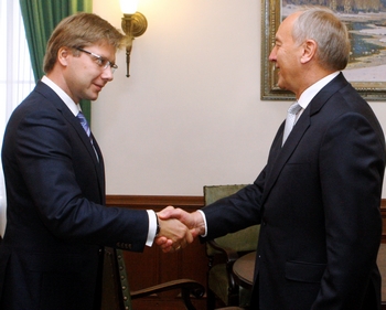 President Andris Berzins schudt de hand van Nils Usakovs